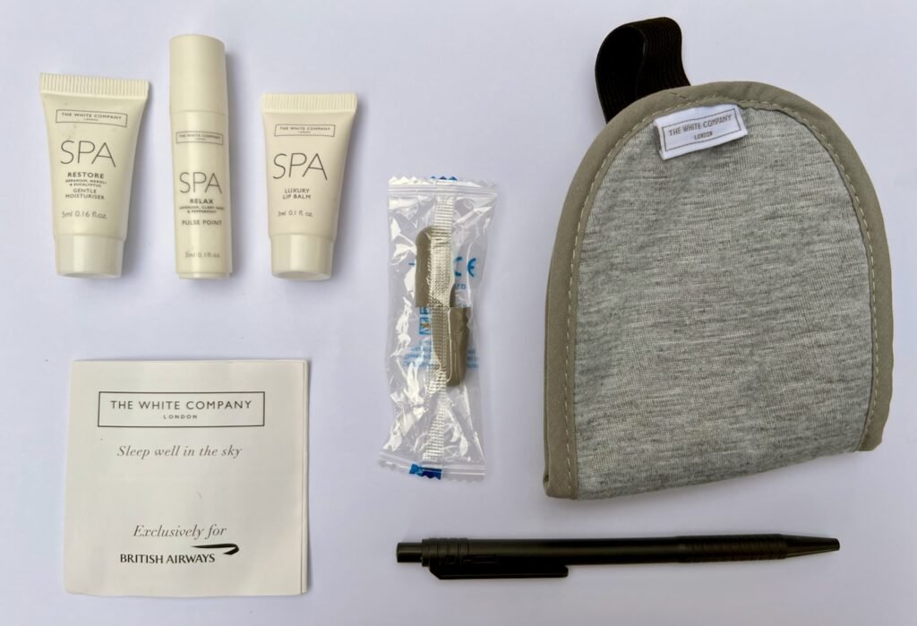 Contents of The White Company amenity kit: moisturiser, pulse point run, lip balm, earplugs, eye mask and pen.  Also toothbrush and toothpaste, not pictured