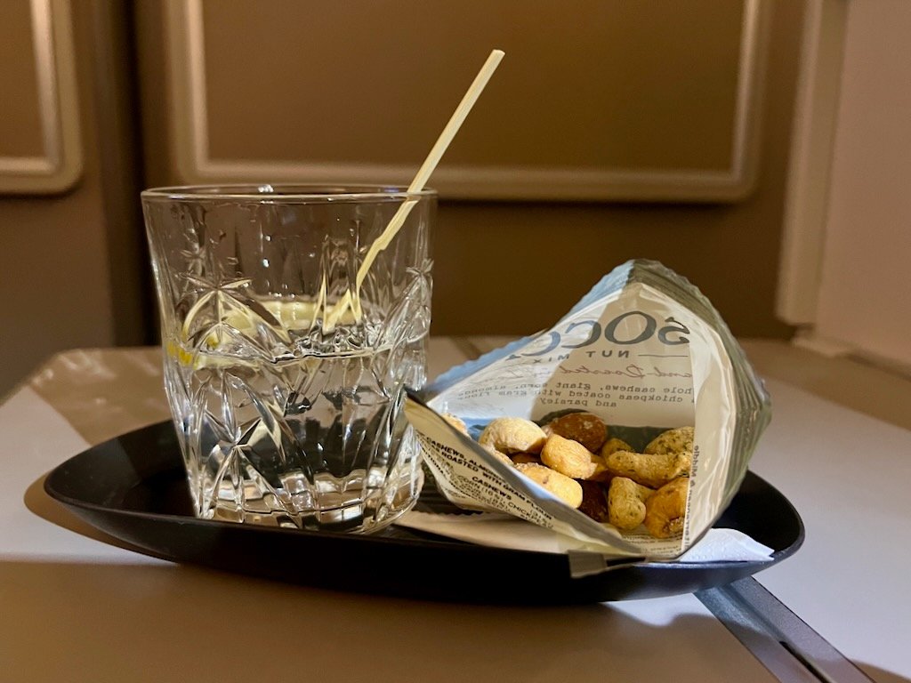 Nuts and a gin and tonic on board our flight.  It took 90 minutes to be served this.