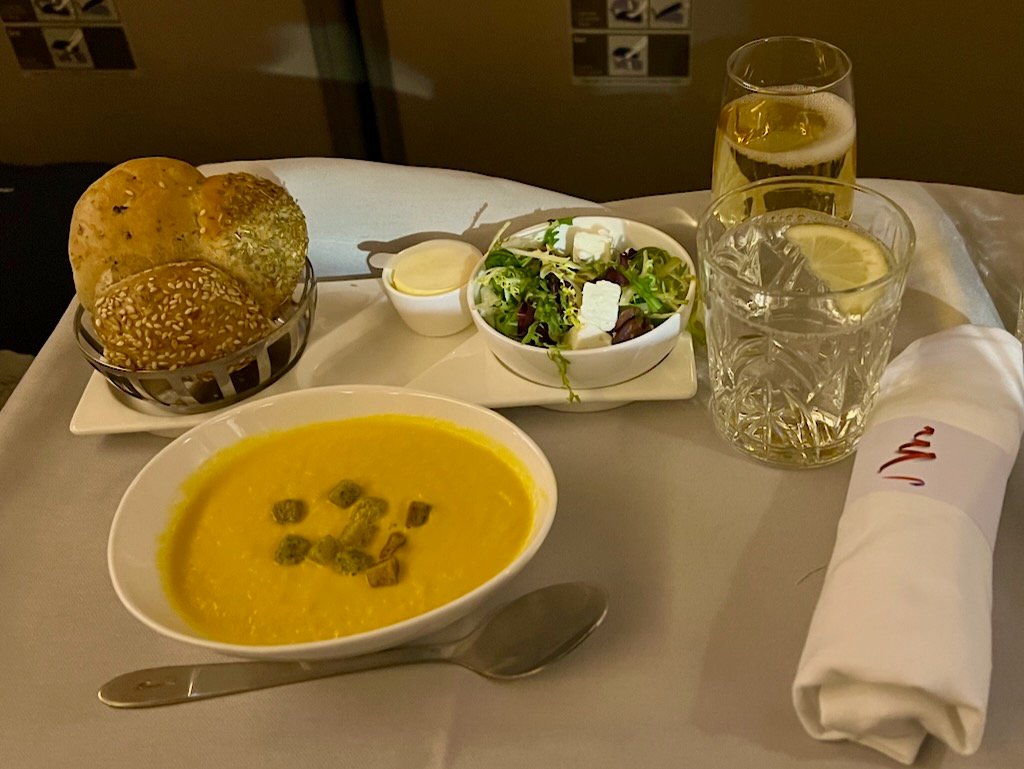 Our starter: carrot and ginger soup, side salad, and BA's three-in-one warm bread roll